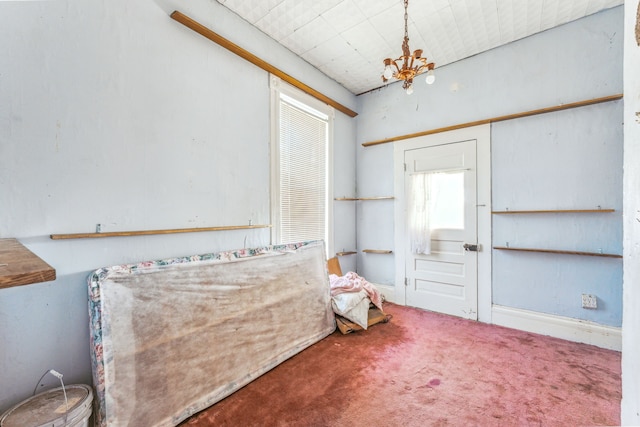 interior space featuring a notable chandelier and carpet flooring