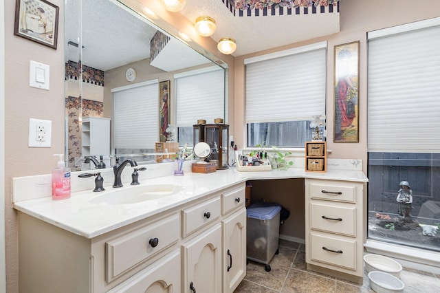 bathroom with a textured ceiling and vanity