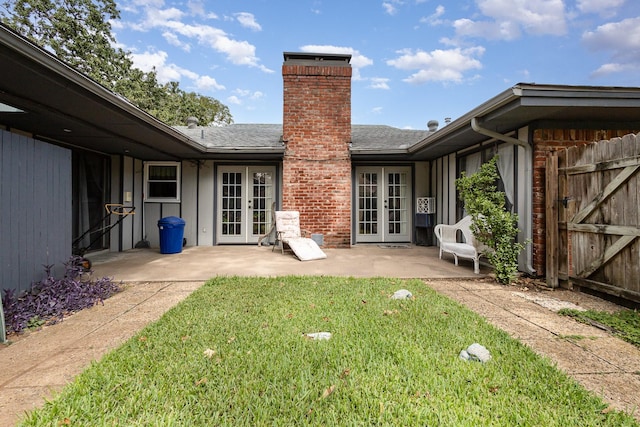 rear view of house featuring a yard, a patio, and french doors