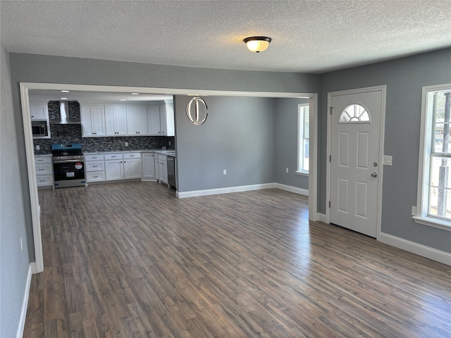 entrance foyer featuring a textured ceiling and dark hardwood / wood-style floors