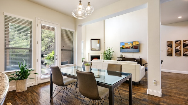 dining space featuring a notable chandelier and dark hardwood / wood-style floors