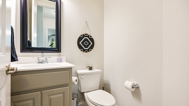 bathroom with toilet and vanity