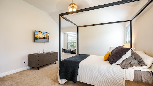 carpeted bedroom featuring vaulted ceiling and ceiling fan