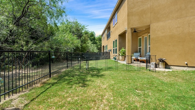 view of yard featuring a patio area and ceiling fan