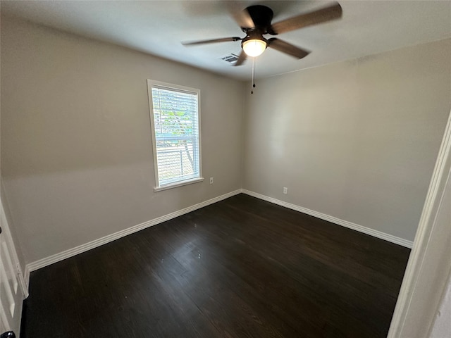 empty room with ceiling fan and dark hardwood / wood-style floors