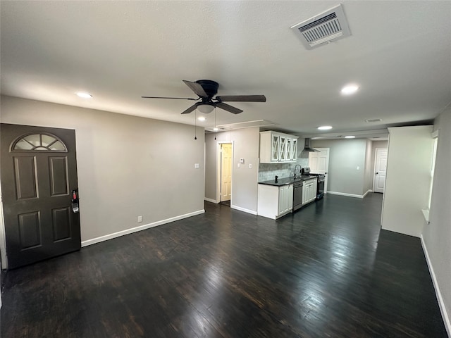 unfurnished living room with ceiling fan and dark hardwood / wood-style flooring