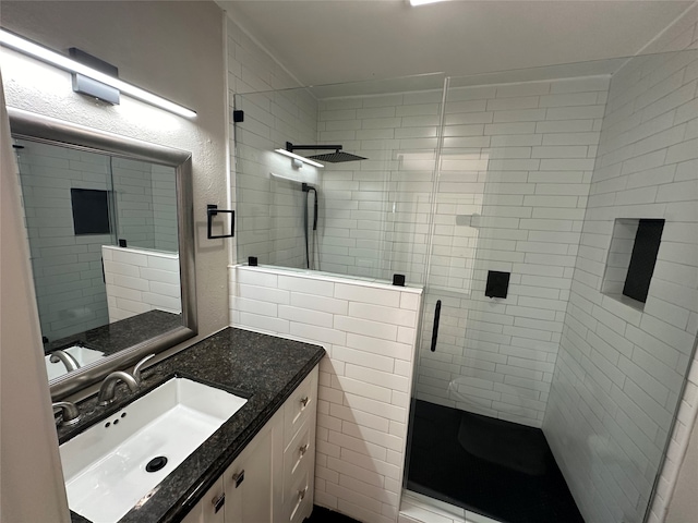 bathroom featuring vanity and a shower with shower door