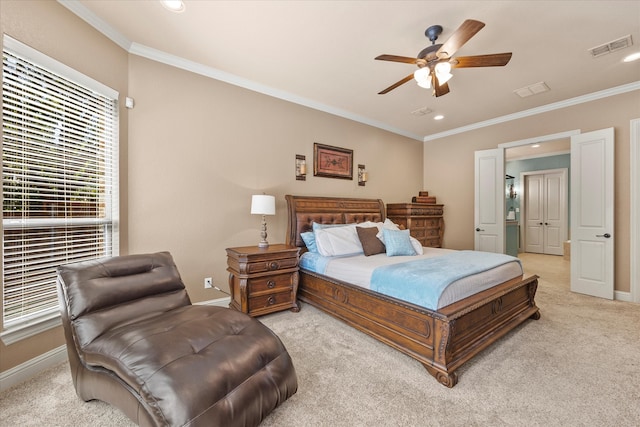 carpeted bedroom featuring ceiling fan and ornamental molding