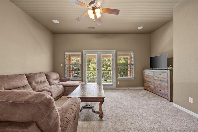 living room featuring light carpet and ceiling fan