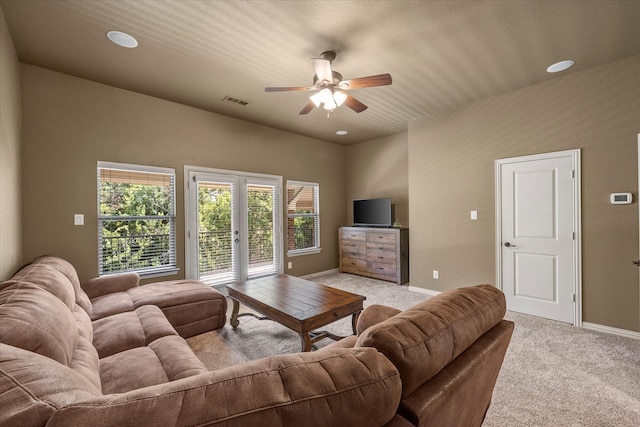 living room with ceiling fan, french doors, and light carpet