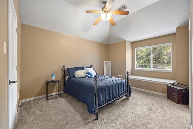 carpeted bedroom with vaulted ceiling and ceiling fan