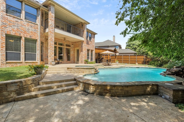 view of pool featuring an in ground hot tub, a patio, and ceiling fan