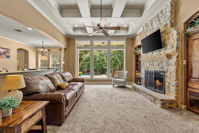 carpeted living room with coffered ceiling, beamed ceiling, crown molding, a fireplace, and ceiling fan with notable chandelier