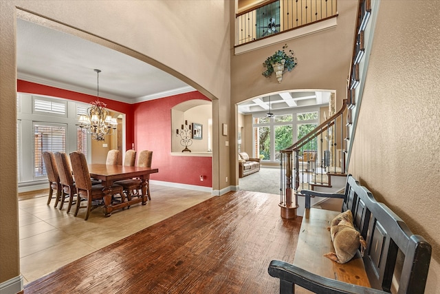 entryway featuring hardwood / wood-style flooring, a notable chandelier, and crown molding