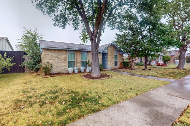 single story home with a front lawn