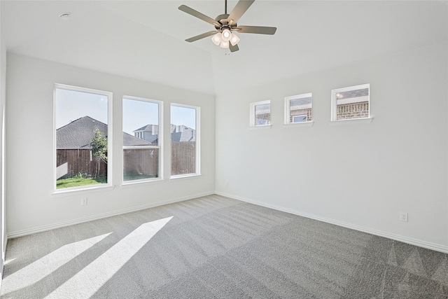 empty room with light carpet, ceiling fan, baseboards, and lofted ceiling