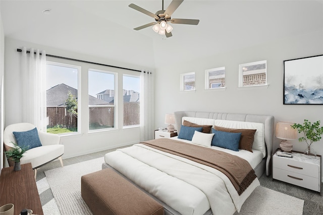 bedroom with vaulted ceiling, ceiling fan, carpet flooring, and baseboards