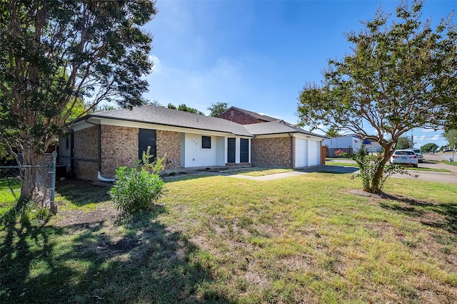 ranch-style home with concrete driveway, brick siding, an attached garage, and a front yard