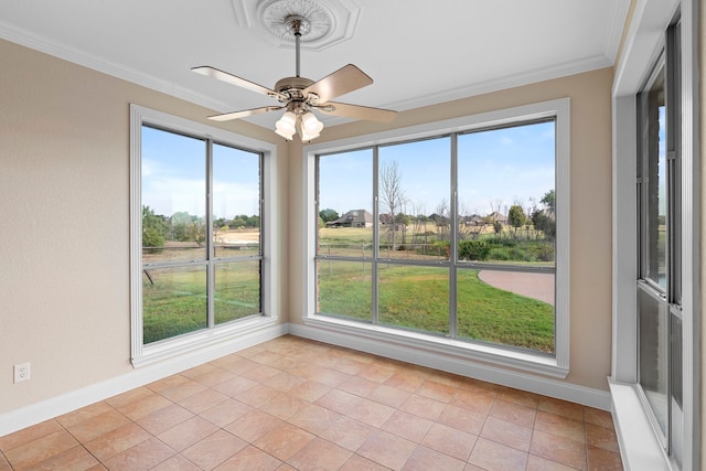 unfurnished sunroom featuring a healthy amount of sunlight and ceiling fan