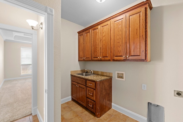 clothes washing area featuring cabinets, light carpet, sink, electric dryer hookup, and hookup for a washing machine