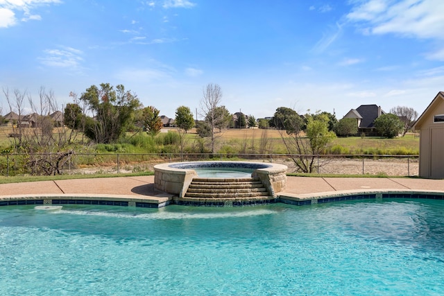 view of swimming pool featuring pool water feature and an in ground hot tub