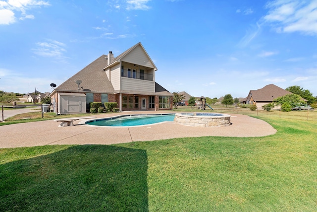 view of pool featuring an in ground hot tub, a yard, and a patio area