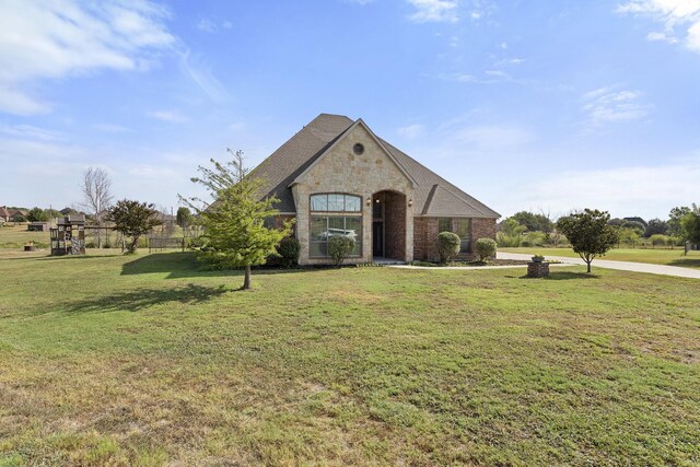 view of exterior entry featuring a lawn