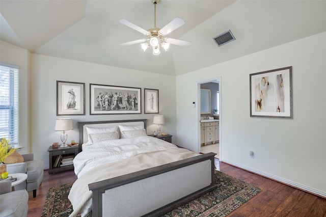 bedroom featuring vaulted ceiling, wood finished floors, visible vents, and baseboards