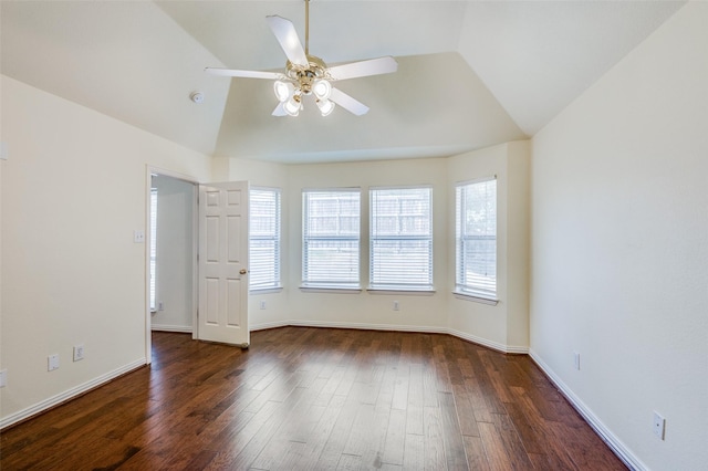 spare room featuring a ceiling fan, lofted ceiling, dark wood-style floors, and baseboards