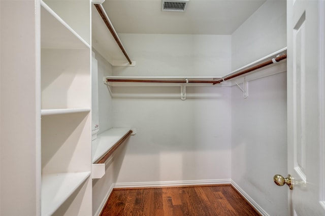 walk in closet featuring visible vents and wood finished floors