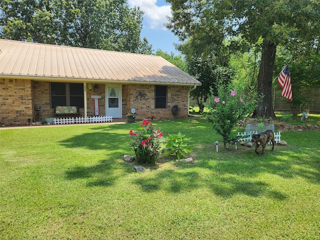 263 County Road 1885, Yantis, TX 75497 - view of front facade with a porch, brick siding, and metal roof