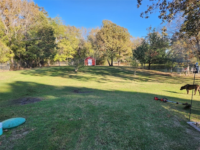 view of community featuring a yard and a shed