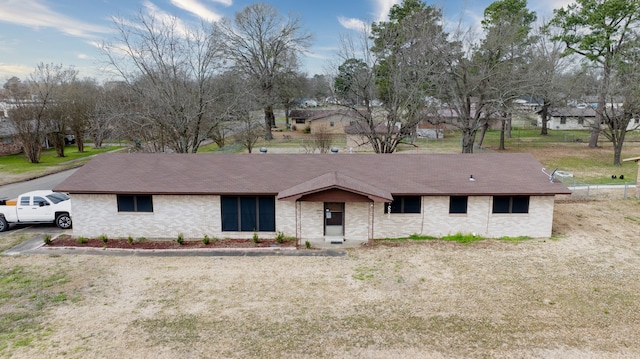 ranch-style home featuring a front yard