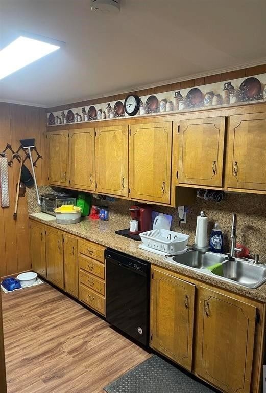 kitchen with light hardwood / wood-style flooring, sink, black dishwasher, decorative backsplash, and ornamental molding