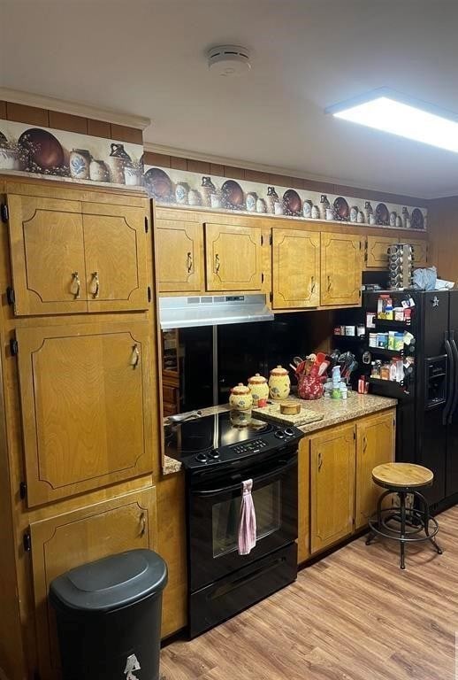 kitchen featuring black appliances and light hardwood / wood-style floors