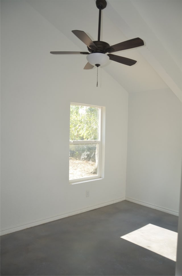 empty room featuring lofted ceiling and ceiling fan