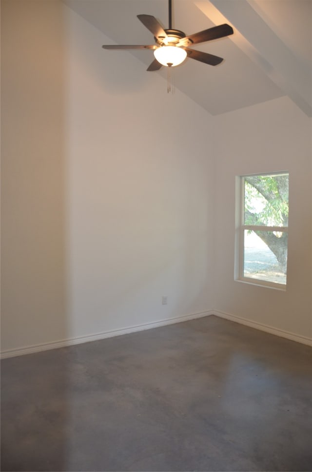 spare room featuring dark carpet, ceiling fan, and lofted ceiling with beams