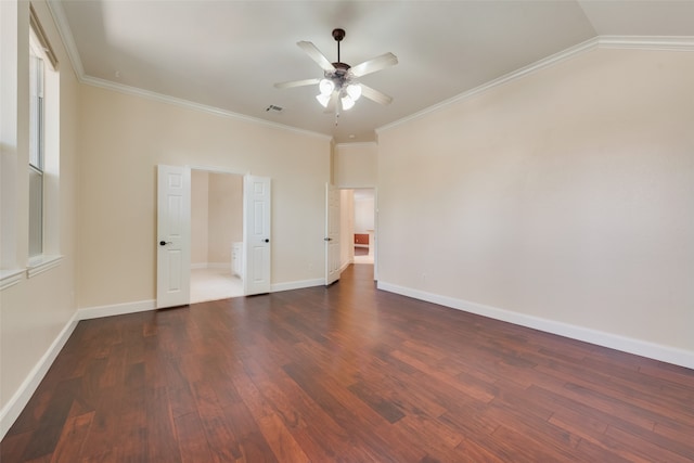 interior space featuring dark wood-type flooring, ceiling fan, vaulted ceiling, and ornamental molding