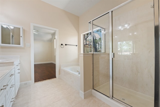 bathroom with tile patterned floors, shower with separate bathtub, and vanity