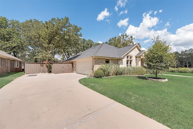 ranch-style home with a garage and a front lawn