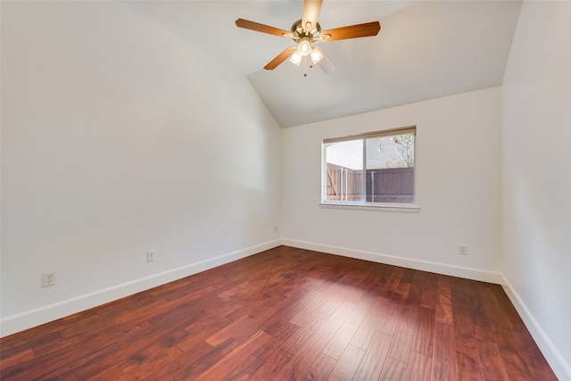 spare room featuring ceiling fan, dark hardwood / wood-style floors, and vaulted ceiling