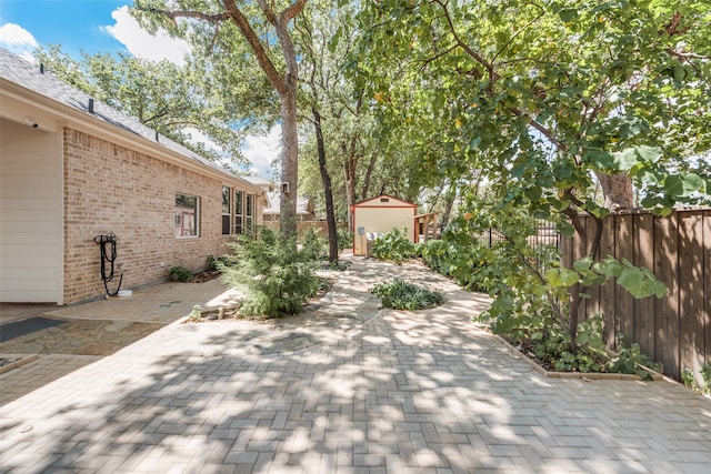 view of patio featuring an outbuilding