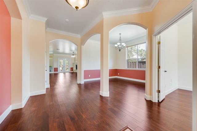 interior space featuring dark wood-type flooring, crown molding, and a notable chandelier