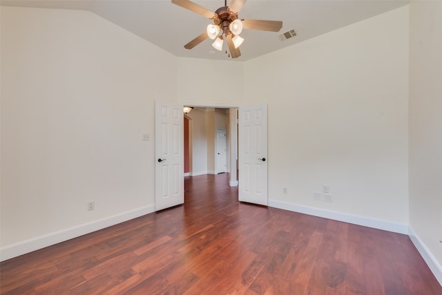 empty room featuring lofted ceiling, ceiling fan, and dark hardwood / wood-style floors