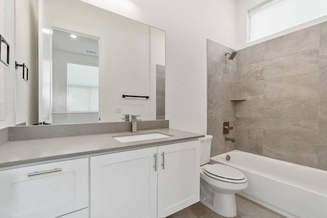 full bathroom with tile patterned flooring, vanity, toilet, and tiled shower / bath