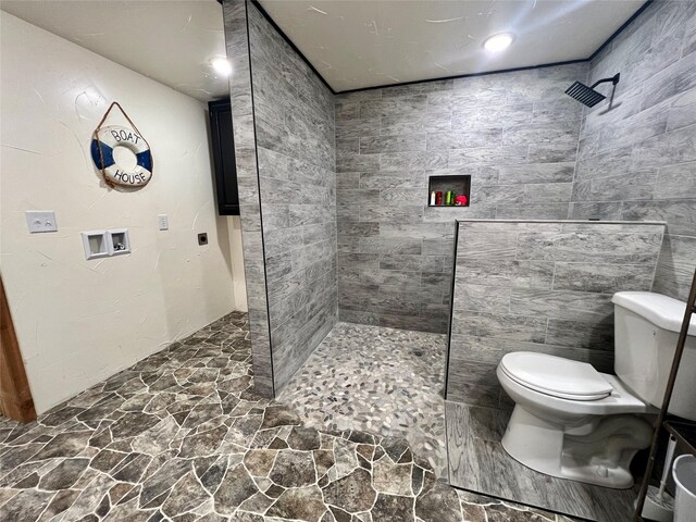 bathroom with stone floors, a walk in shower, and toilet