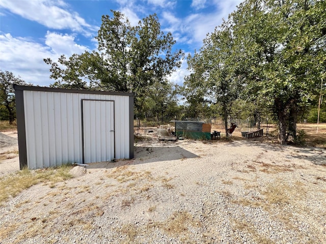 view of shed with fence