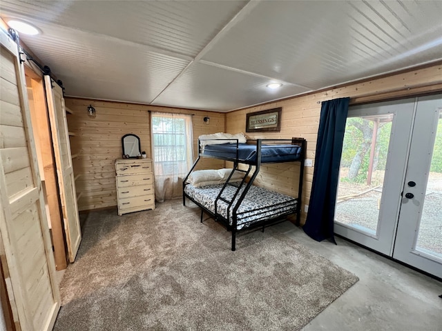 bedroom featuring multiple windows and wooden walls