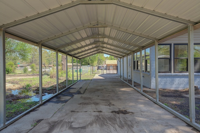 unfurnished sunroom featuring vaulted ceiling and a wealth of natural light