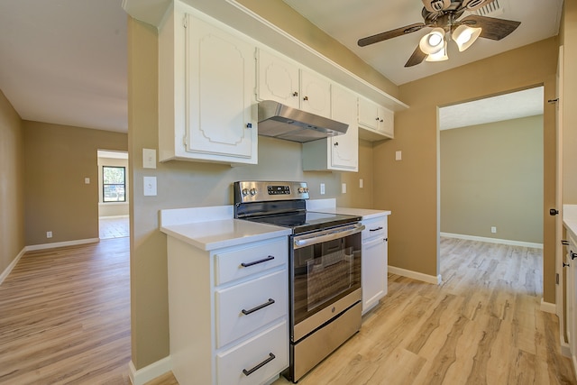 kitchen featuring ceiling fan, electric stove, light wood-type flooring, and white cabinetry